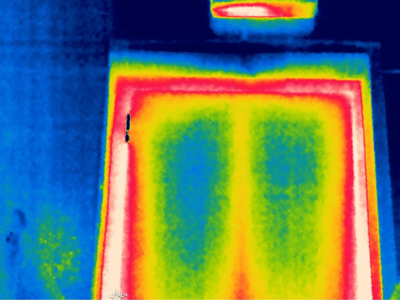 Aerial thermal image of a clad industrial roof showing a regular grid of warmer fixing and joint lines